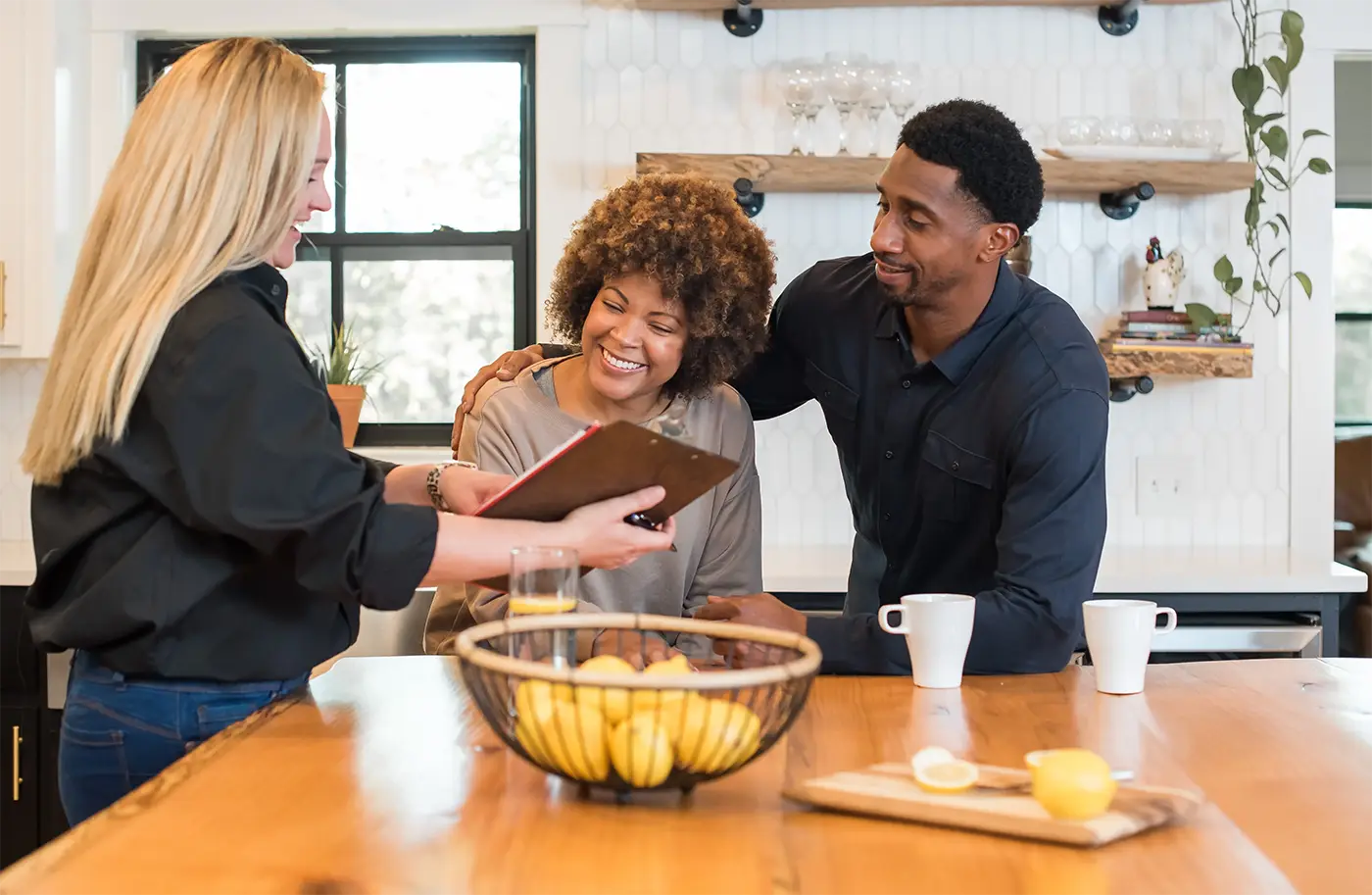 HVAC dealer meeting with happy couple in kitchen | Epic A/C Service | epicacguy.com