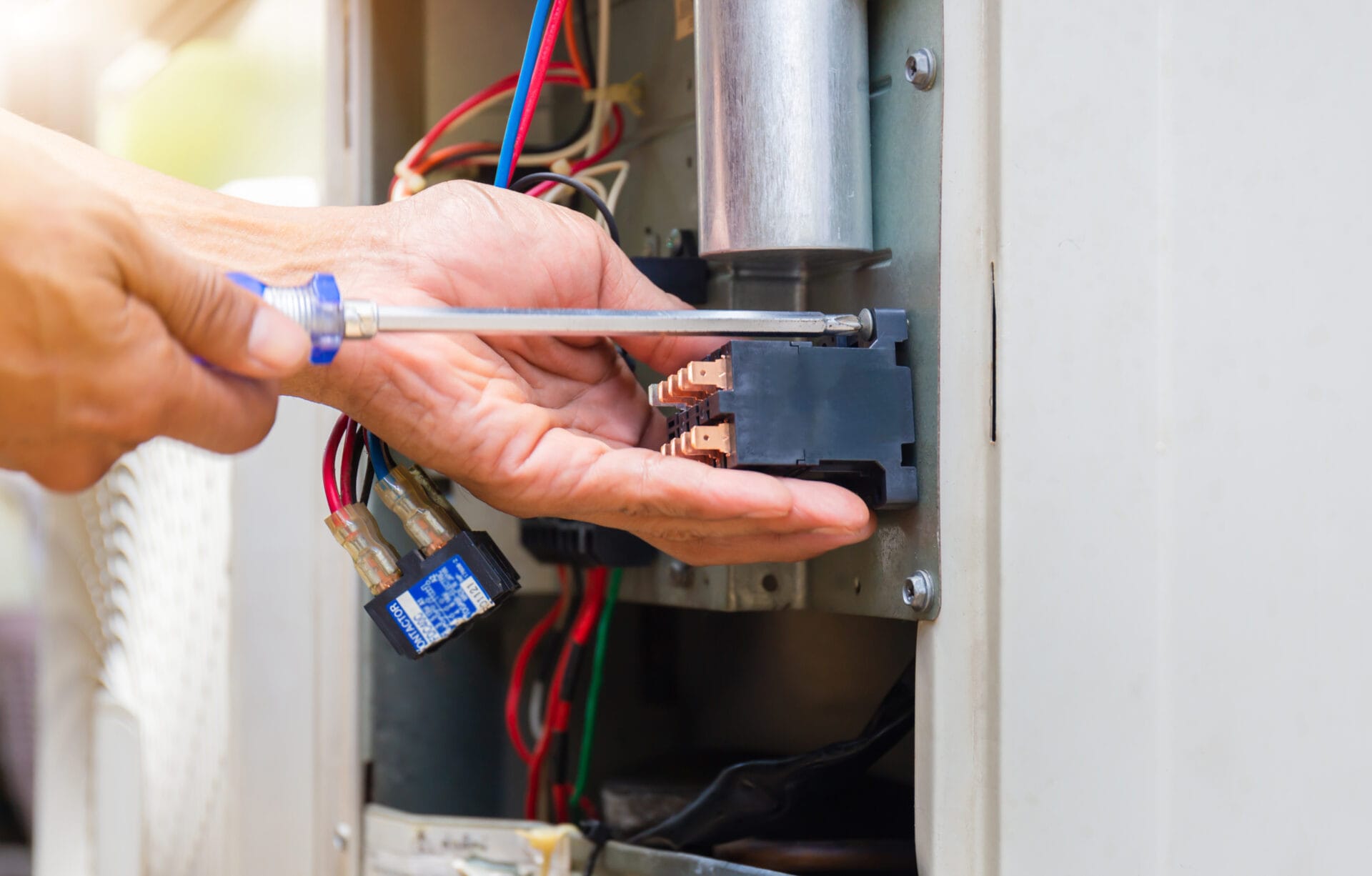 Close up of Air Conditioning Repair, repairman installing magnetic contactor and fixing air conditioning system.